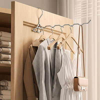 cintre metallique pliant inox ouvert sur porte bois clair petit sac marron