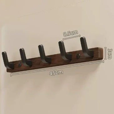 porte manteau bois fonce cinq crochets noirs mur creme